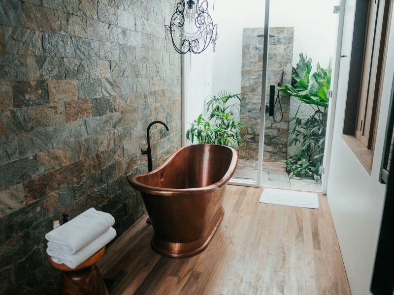 brown plastic bucket near white framed glass door